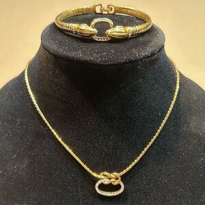 Vintage Necklace and Bracelet set. Featuring gold design adorned in white gems.​